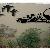 steel silhouette of ducks flying toward southwestern mountains.

